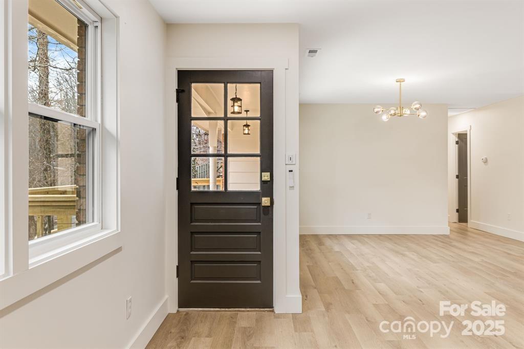 7 Angus Lane Asheville, NC 28805 - Photo 18 of 45 a view of an entryway with wooden floor and a window