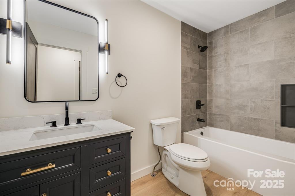 7 Angus Lane Asheville, NC 28805 - Photo 21 of 45 a bathroom with a toilet a sink a tub and mirror