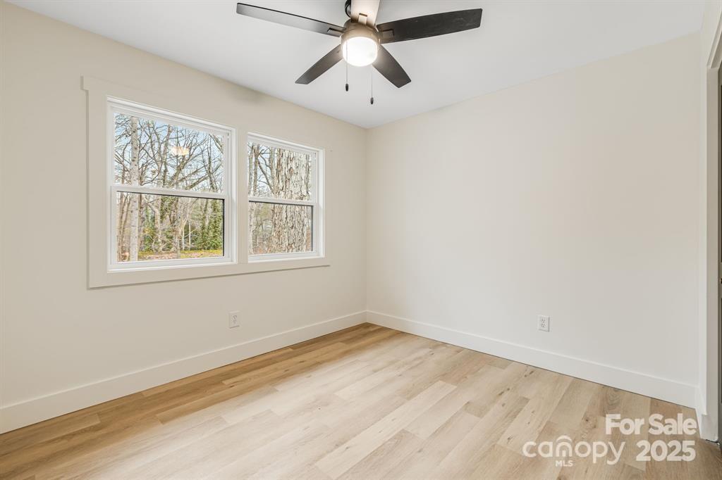 7 Angus Lane Asheville, NC 28805 - Photo 23 of 45 a view of empty room with window and wooden floor