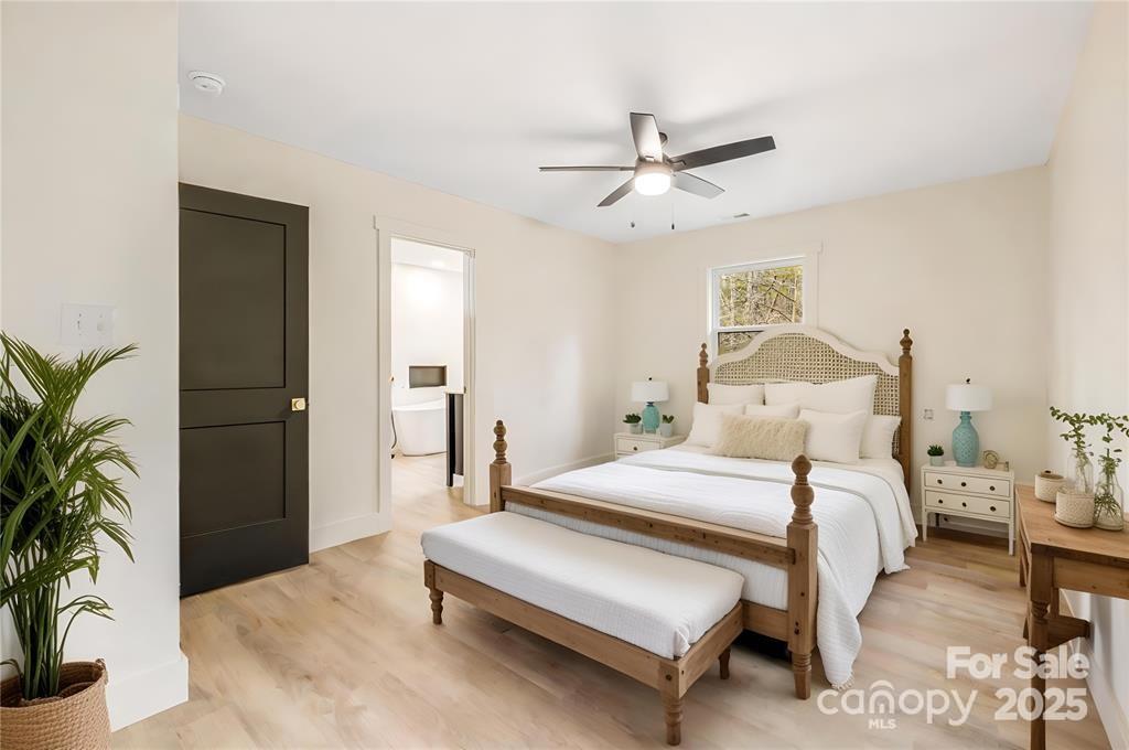 7 Angus Lane Asheville, NC 28805 - Photo 29 of 45 a bedroom with a bed and a potted plant