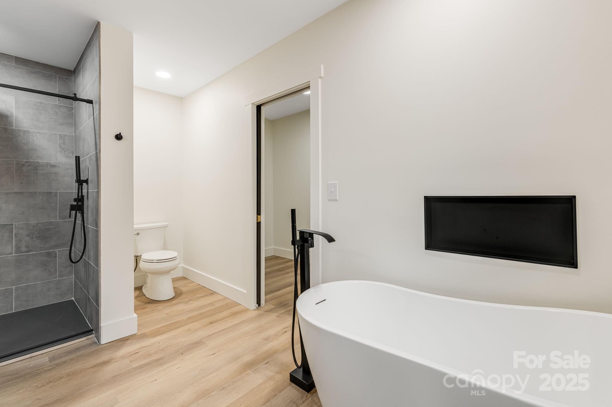 7 Angus Lane Asheville, NC 28805 - Photo 32 of 45 a bathroom with a bathtub and a toilet