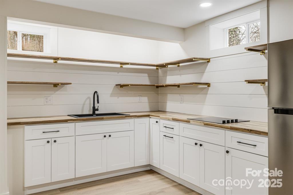 7 Angus Lane Asheville, NC 28805 - Photo 40 of 45 a kitchen with white cabinets and sink