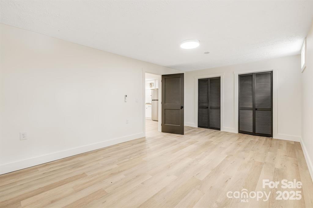 7 Angus Lane Asheville, NC 28805 - Photo 44 of 45 a view of an empty room with wooden floor