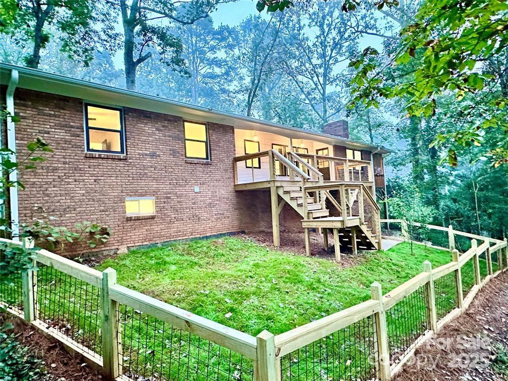 7 Angus Lane Asheville, NC 28805 - Photo 5 of 45 a view of a house with wooden deck and a yard