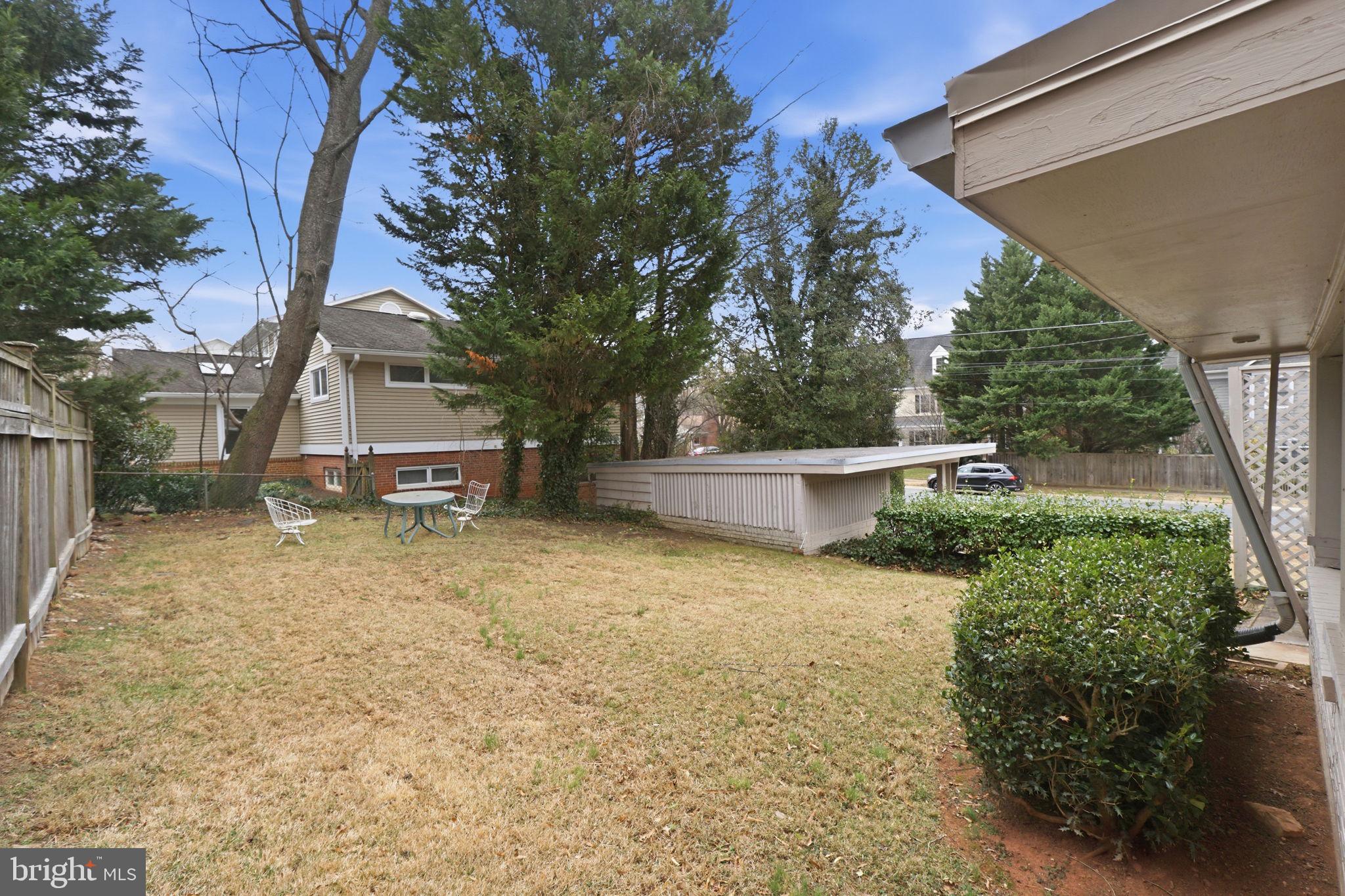 6104 Kirby Road Bethesda, MD 20817 - Photo 6 of 7 a backyard of a house with outdoor seating and plants