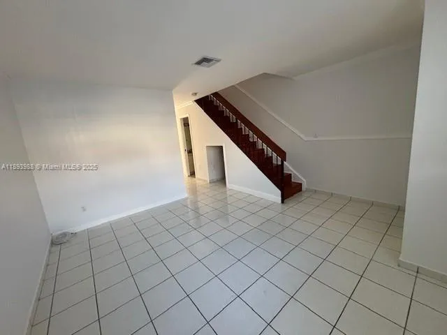 a kitchen with a sink a refrigerator and a stove top oven