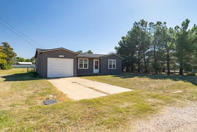 a house view with swimming pool in front of it