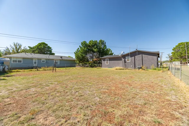 a swimming pool with outdoor seating and yard