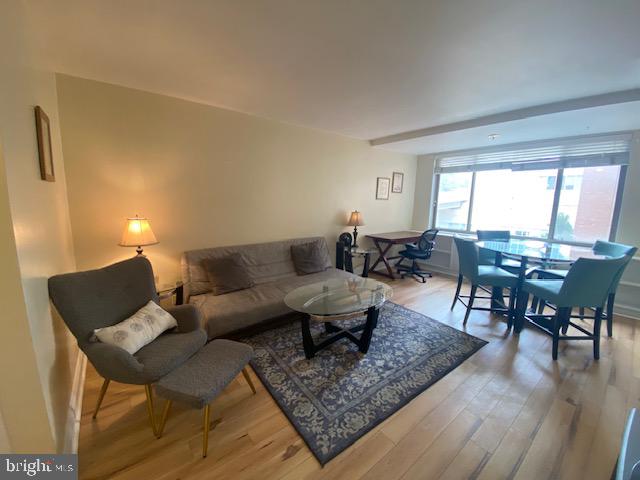 1121 Arlington Boulevard, Unit 325 Arlington, VA 22209 - Photo 1 of 39 a living room with furniture and wooden floor