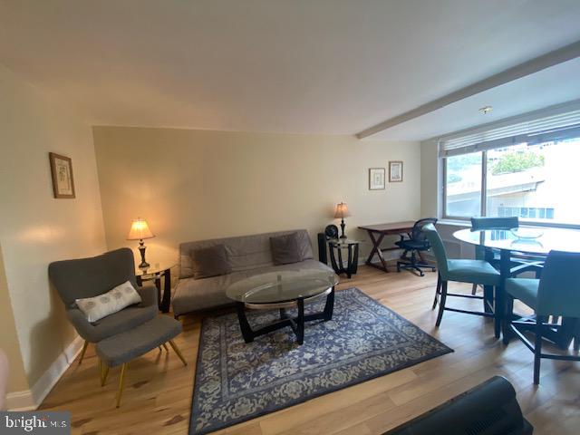1121 Arlington Boulevard, Unit 325 Arlington, VA 22209 - Photo 11 of 39 a living room with furniture and a large window