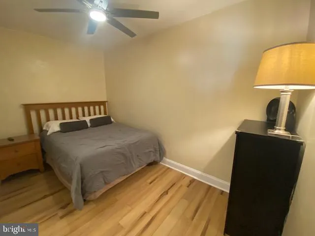 a bedroom with a bed and a lamp