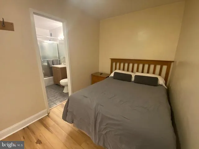 a bedroom with a bed and lamp