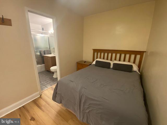 1121 Arlington Boulevard, Unit 325 Arlington, VA 22209 - Photo 16 of 39 a bedroom with a bed and lamp