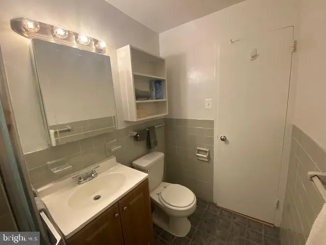 a bathroom with a sink toilet and mirror