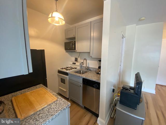 1121 Arlington Boulevard, Unit 325 Arlington, VA 22209 - Photo 8 of 39 a kitchen with stainless steel appliances granite countertop a sink stove and refrigerator