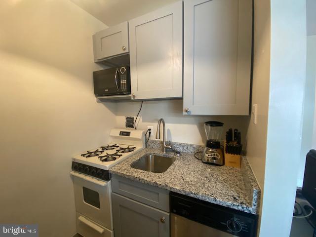 1121 Arlington Boulevard, Unit 325 Arlington, VA 22209 - Photo 9 of 39 a kitchen with a sink a stove and cabinets