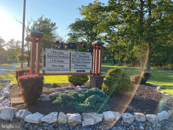 a view of a swimming pool with a patio and a yard