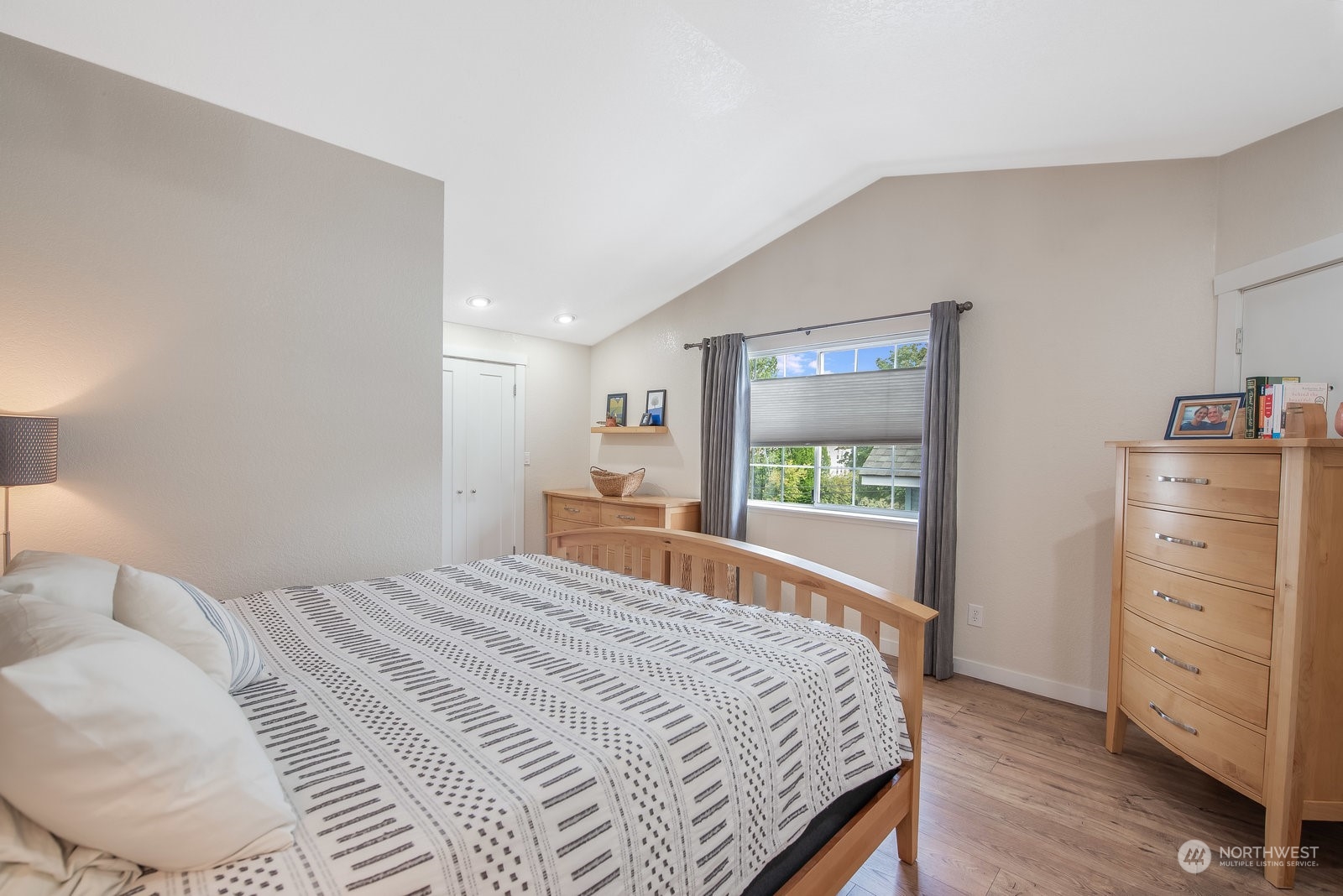 2605 Rucker Avenue, Unit 301 Everett, WA 98201 - Photo 16 of 29 a bedroom with a large bed and a flat tv screen on dresser