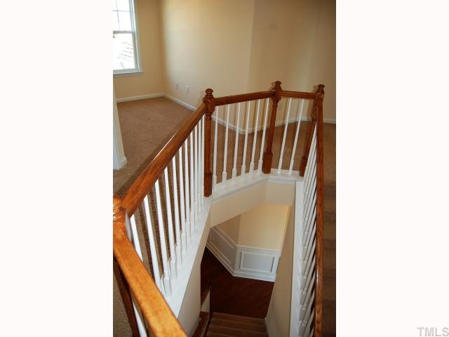 1208 Chapanoke Road Raleigh, NC 27603 - Photo 8 of 12 a view of staircase with railing and white walls