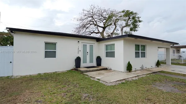 a view of a backyard with a tree