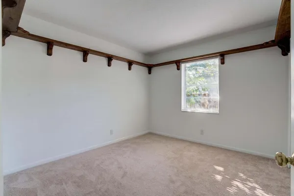 a view of a big room with windows and closet