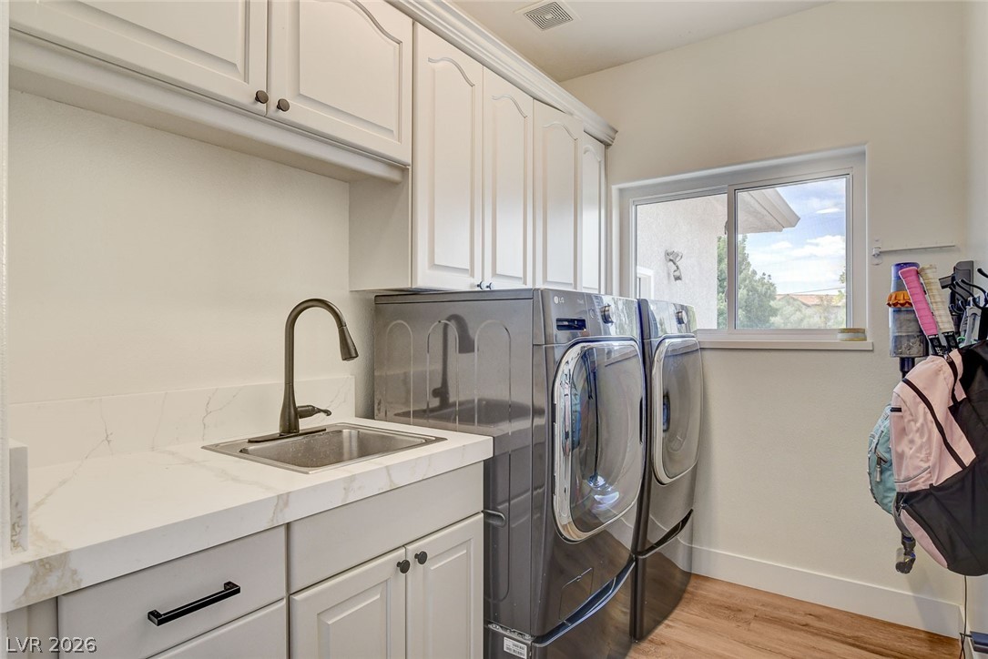 4362 Thistle Street Logandale, NV 89021 - Photo 62 of 99 Functional laundry room offers a convenient sink and ample cabinet storage.
