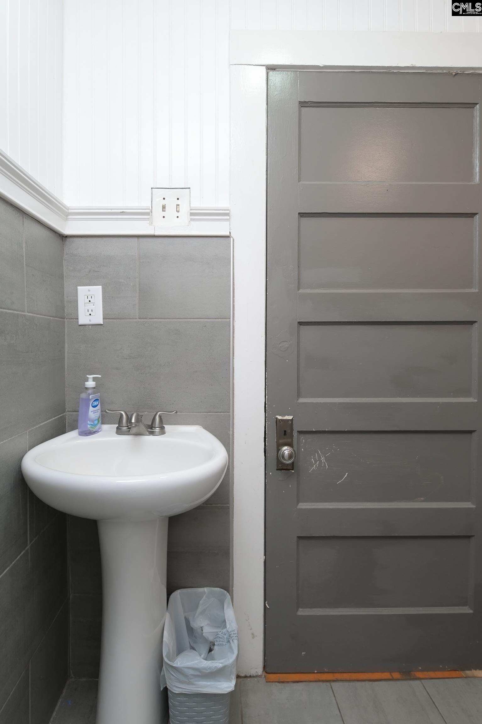 2227 Bull Street Columbia, SC 29201 - Photo 20 of 38 a bathroom with a sink a toilet and a mirror