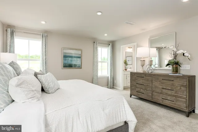 a bedroom with a bed and a dresser