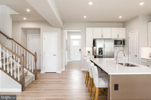a kitchen with counter top space cabinets and wooden floor