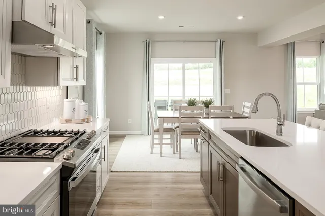 a kitchen with a sink and a stove top oven