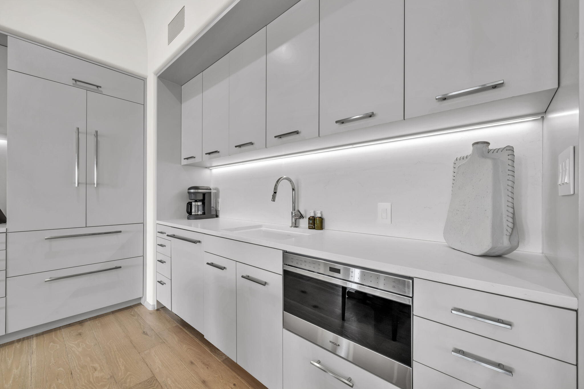 45 West Solaire Way Inlet Beach, Unit 207 Inlet Beach, FL 32461 - Photo 20 of 55 a kitchen with white cabinets and white appliances