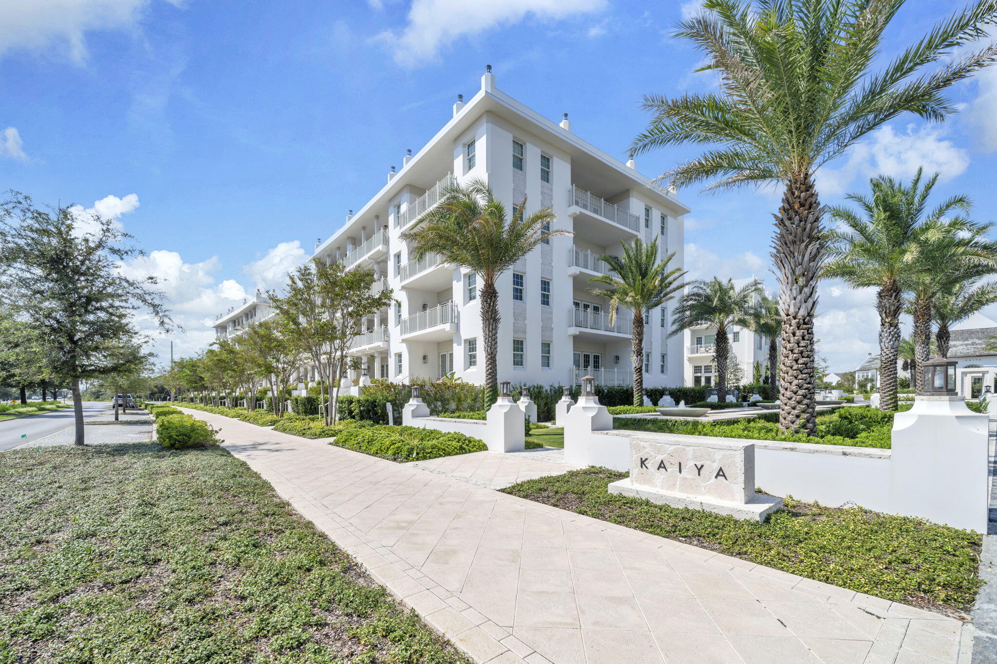45 West Solaire Way Inlet Beach, Unit 207 Inlet Beach, FL 32461 - Photo 5 of 55 a front view of a house with a yard and palm trees