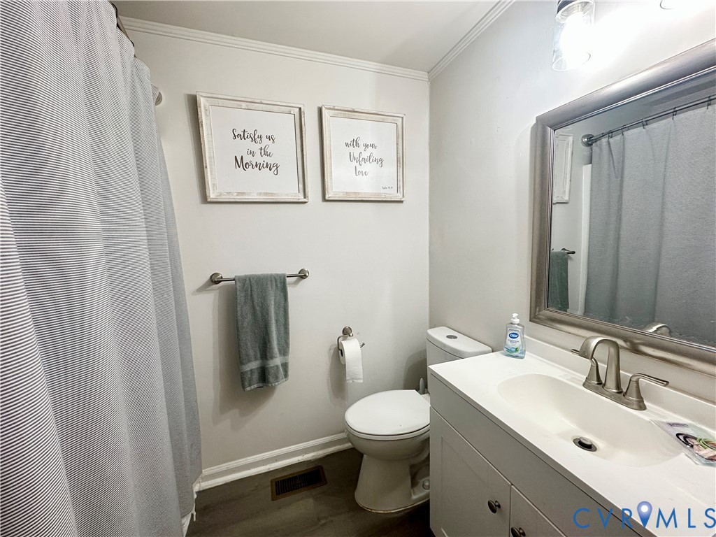 7406 Stubbs Bridge Road Spotsylvania, VA 22551 - Photo 13 of 13 a bathroom with a toilet sink and mirror