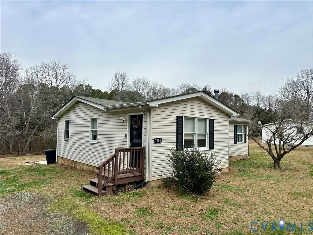 7406 Stubbs Bridge Road Spotsylvania, VA 22551 - Photo 2 of 13 a view of a house with a yard and a garden