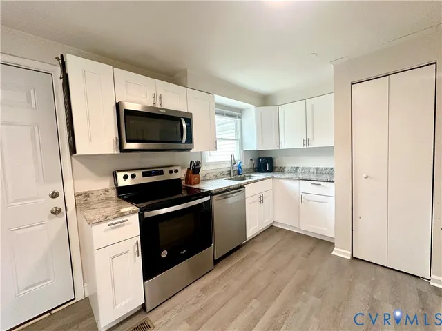 a kitchen with a stove a sink and a microwave