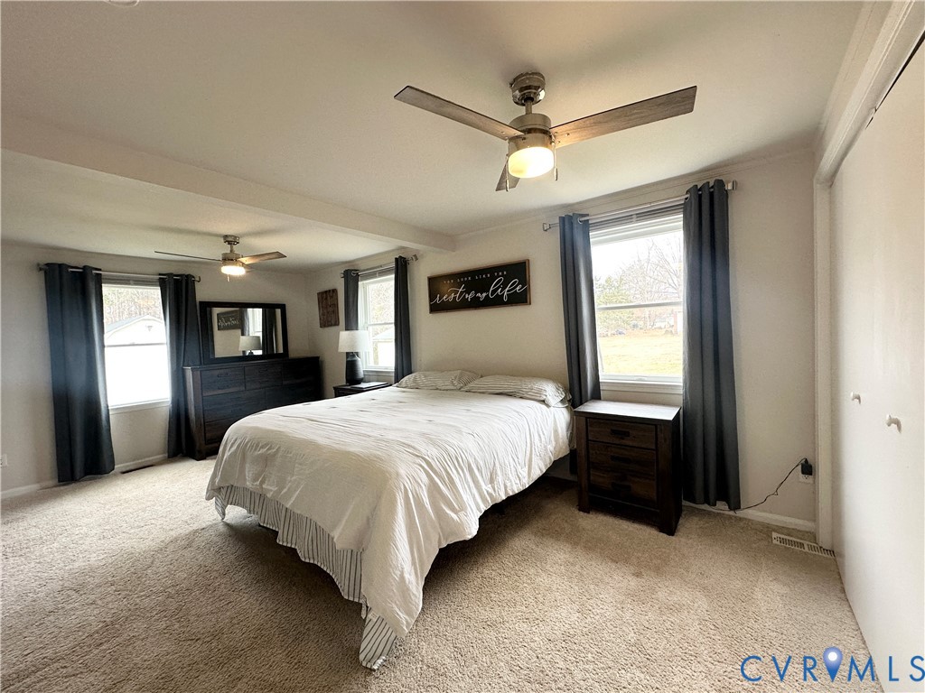 7406 Stubbs Bridge Road Spotsylvania, VA 22551 - Photo 10 of 13 a bed sitting in a spacious bedroom next to a window