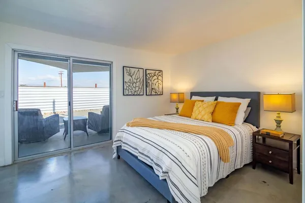 a bedroom with a bed and a couch