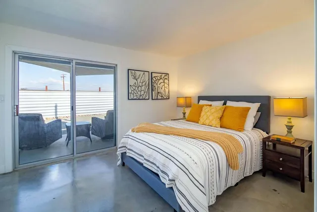 a bedroom with a bed and a couch