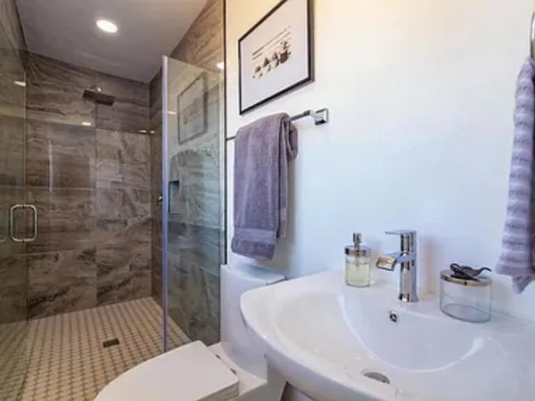a bathroom with a sink toilet and shower