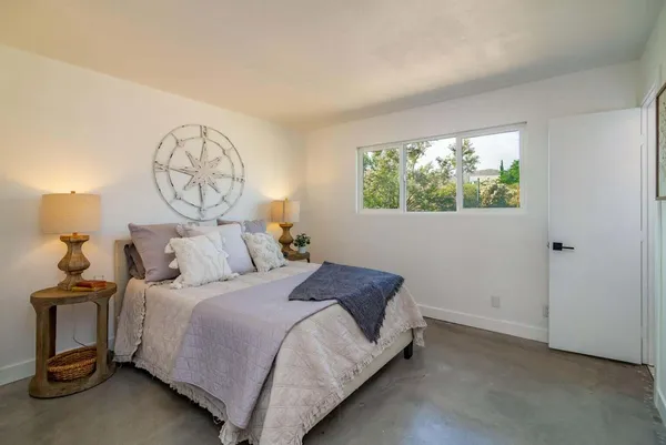 a bedroom with bed and a window