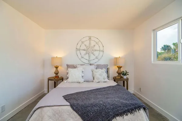 a bedroom with a bed and a window