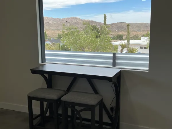 a balcony with table and chairs