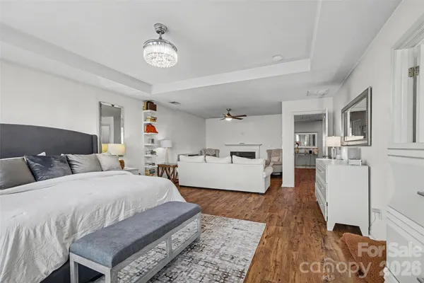 a bedroom with a bed and a flat tv screen on dresser