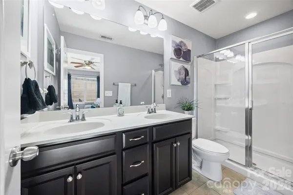 a spacious bedroom with a bed and a wooden floor