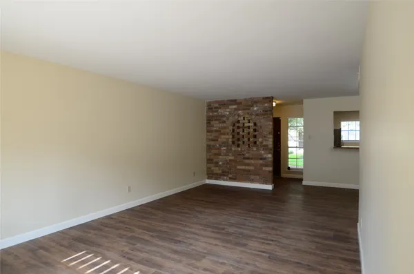 a view of a room with wooden floor