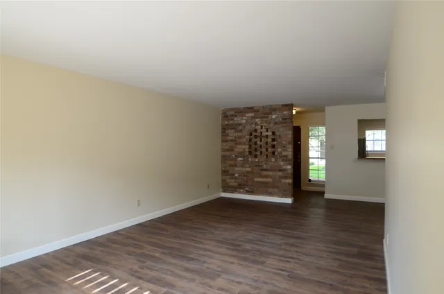a view of a room with wooden floor