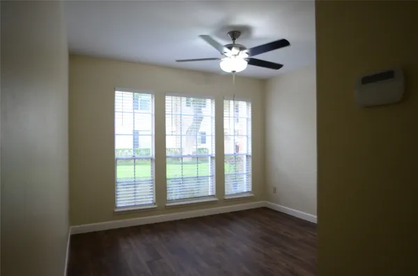 a view of wooden floor and a chandelier in a room