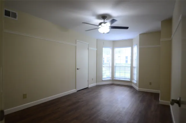 a view of a car parked in front of a house with a yard