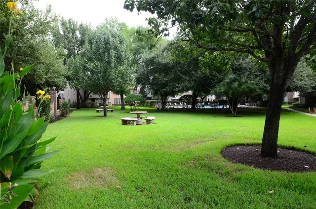a view of a house with pool and chairs