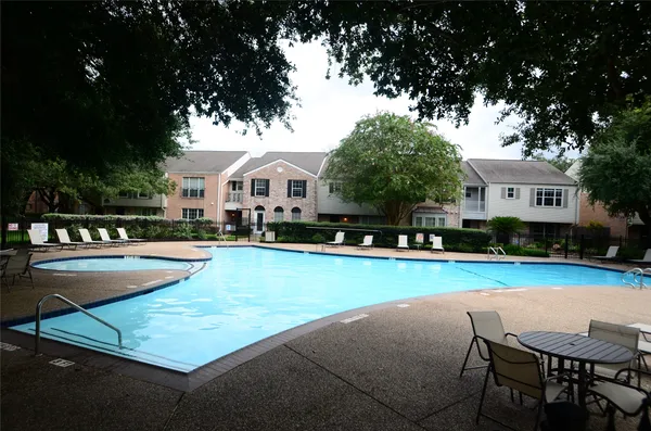 a view of street with houses and trees in the background